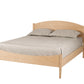 A light natural wood platform bed frame with a curved headboard and footboard, shown with beige bedding and two pillows on a solid white background.