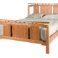 An Asian inspired bed with a Cherry wood frame and headboard, dressed in white bedding and two white pillows, shown against a plain white background.