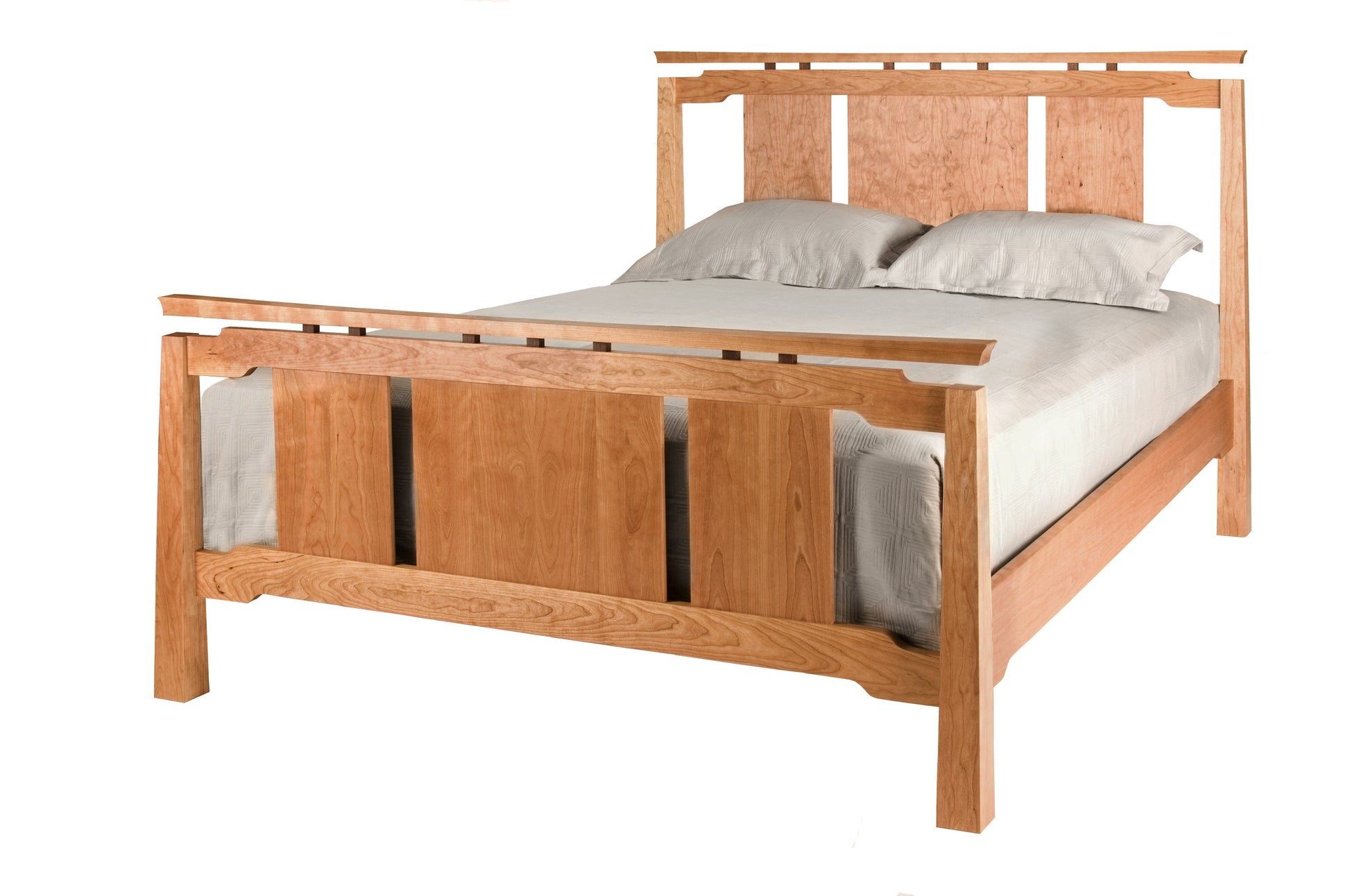 An Asian inspired bed with a Cherry wood frame and headboard, dressed in white bedding and two white pillows, shown against a plain white background.