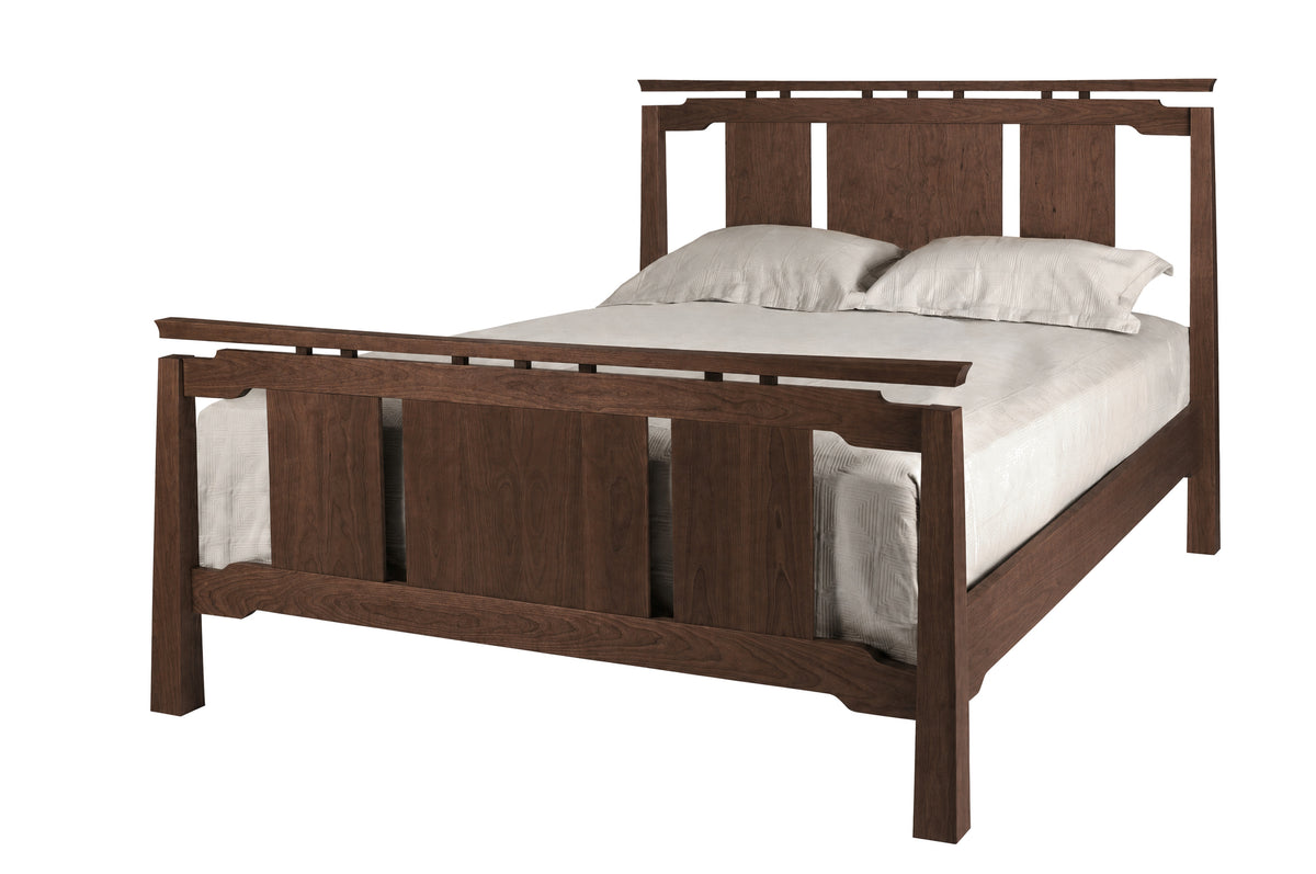 An Asian inspired bed with a dark Walnut wood frame and headboard, dressed in white bedding and two white pillows, shown against a plain white background.