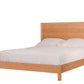 A Cherry wood bed frame with a tall panel headboard and matching footboard, shown with white bedding and two white pillows on a solid white background.