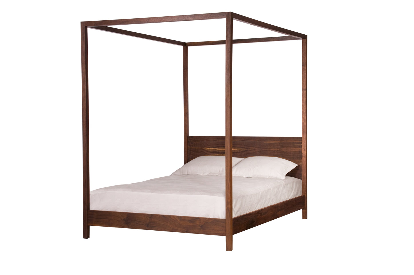 A dark brown Walnut wooden four-poster bed frame with a headboard, shown with white bedding and pillows on a solid white background.