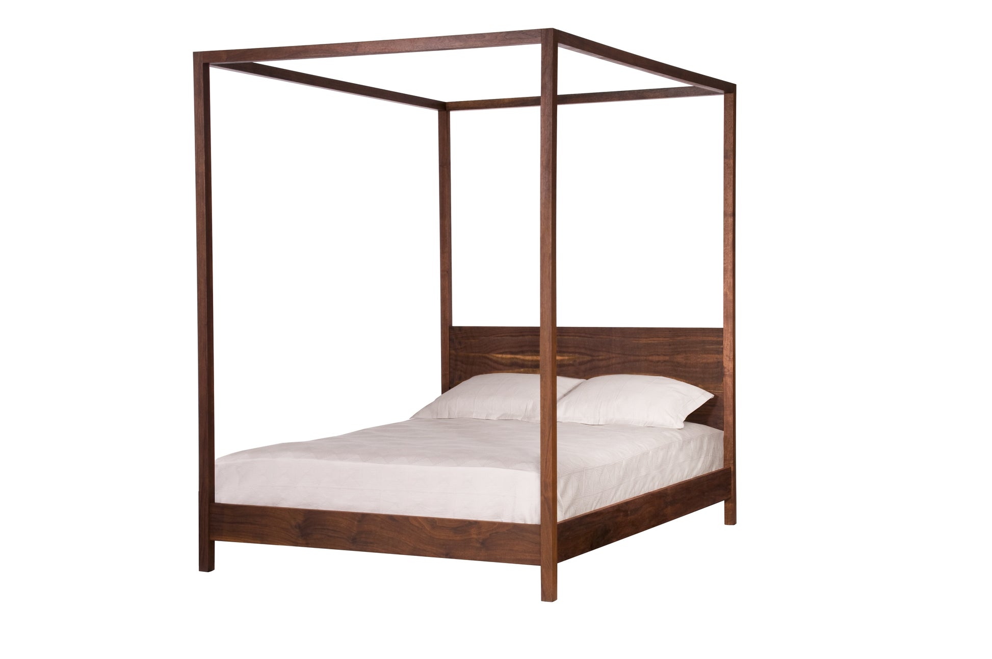A dark brown Walnut wooden four-poster bed frame with a headboard, shown with white bedding and pillows on a solid white background.