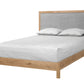 A modern platform bed with a light oak wood frame and a gray upholstered headboard, shown with white bedding and two pillows on a solid white background.