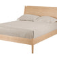 A mid-century modern Maple wooden bed frame, styled with a cream-colored mattress and two matching pillows, shown against a solid white background.