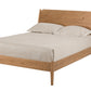 A mid-century modern wooden bed frame with a natural oak finish, shown with a light beige linen sheet and two pillows against a solid white background.