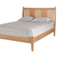 Contemporary Oak wood bed with slats and panels on headboard. Featuring light toned bedding and matching pillows on white background. 