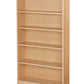 A tall, five-shelf wooden bookcase in a light natural oak finish, shown from a three-quarter angle against a plain white background.