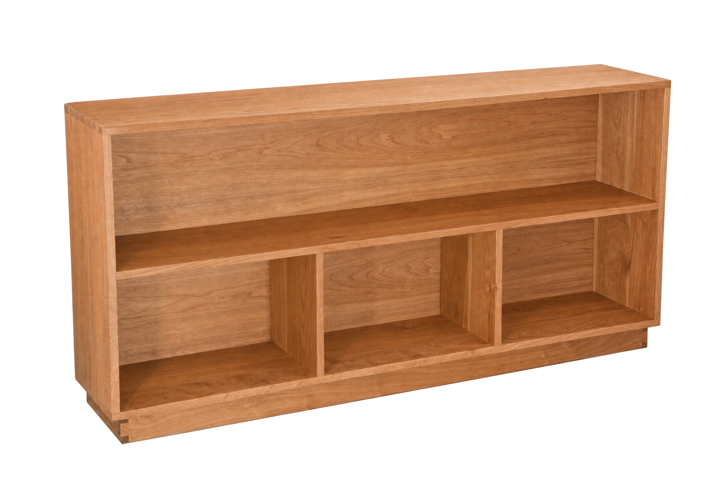 A wooden bookcase with three open cubbies, shown from a three-quarter angle on a solid white background.