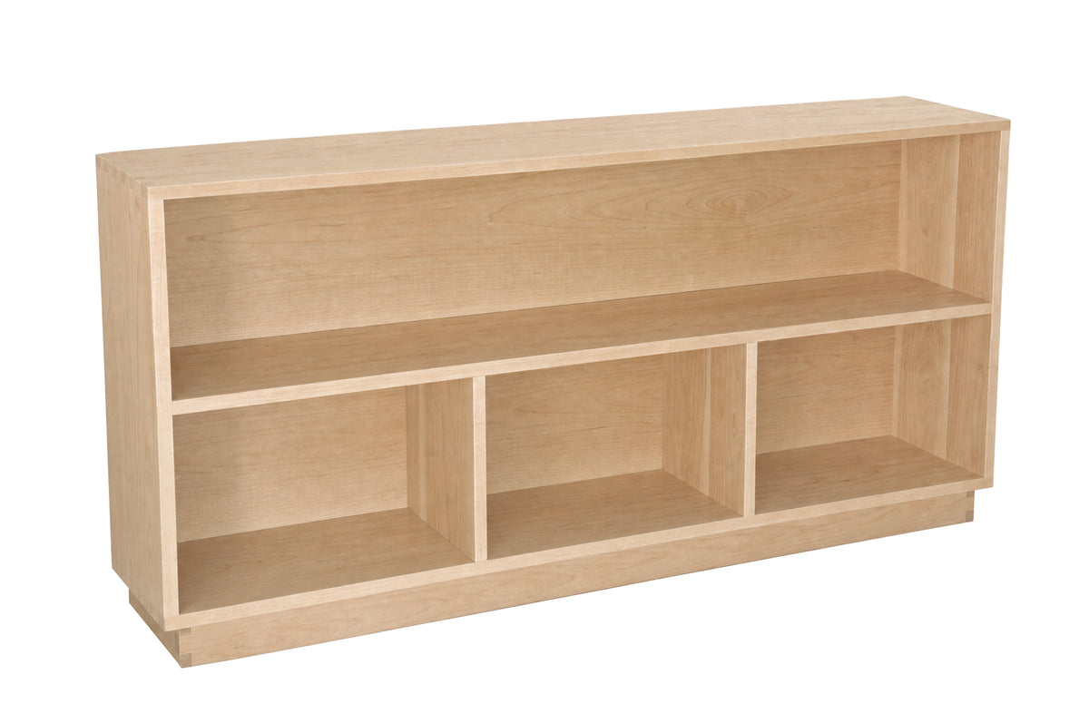 A light natural wood open bookcase with three cubby shelves, shown from a three-quarter angle on a solid white background.