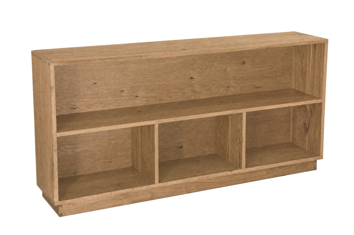 A light brown wooden bookcase with three open cubbies, shown from a three-quarter angle on a solid white background.