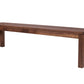 A dark brown wooden bench with a rectangular seat and four sturdy legs, shown from a three-quarters angle on a solid white background.