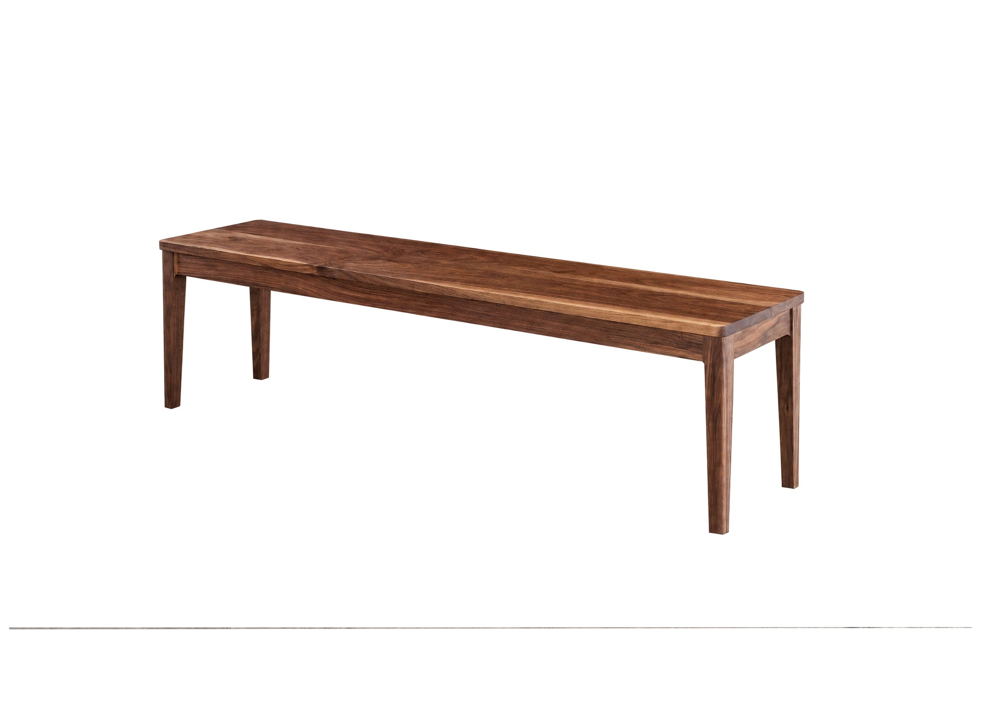 A long wooden bench with a medium brown finish and visible wood grain, shown from a three-quarters angle on a plain white background.
