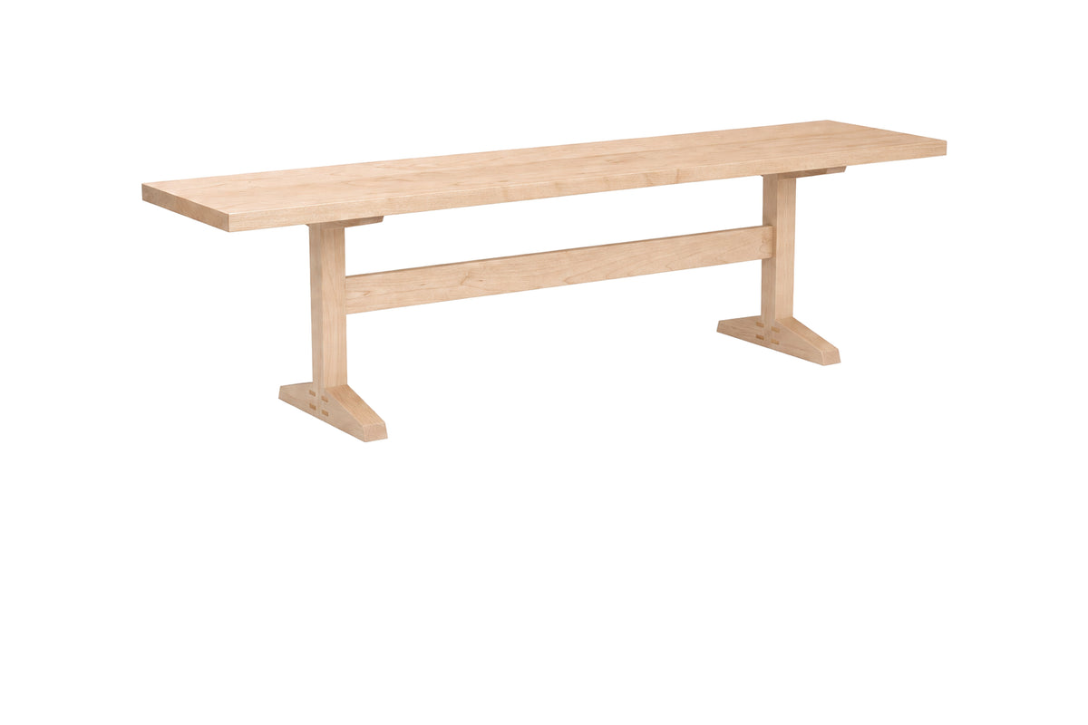 A light natural wood bench with a rectangular seat and two angled support legs connected by a horizontal stretcher bar, shown on a plain white background.