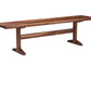 A rustic wooden bench with a dark brown finish, featuring a thick plank seat and angled trestle-style legs, isolated on a white background.