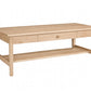 A light natural wood coffee table with a single drawer, a lower shelf, and a round wooden pull handle, shown on a plain white background.