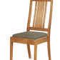 A wooden dining chair with a natural oak finish and a textured gray upholstered seat cushion, shown against a plain white background.