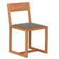 A modern wooden dining chair with a warm medium-brown wood frame and a textured gray fabric seat cushion, shown against a plain white background.