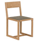 A modern wooden dining chair with a light oak frame and a textured gray fabric seat cushion, shown from a three-quarters angle on a white background.