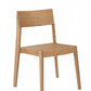 A minimalist light oak wood dining chair with a rectangular backrest and tapered legs, shown from a three-quarter angle on a solid white background.