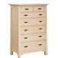 A tall 7 drawer dresser with light Maple finish and dark wood pulls, shown from a three-quarter angle on a white background.