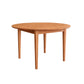 A round wooden dining table with a warm medium-brown finish and four tapered legs, shown on a plain white background.