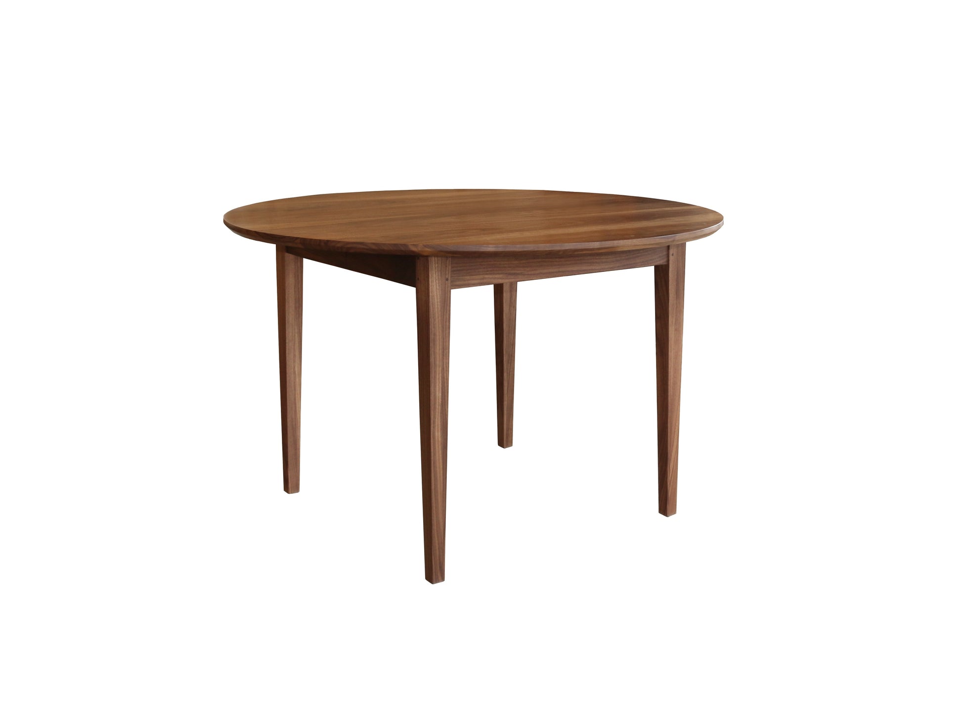 A round wooden dining table with a medium brown finish and four tapered legs, shown from a three-quarters angle on a solid white background.
