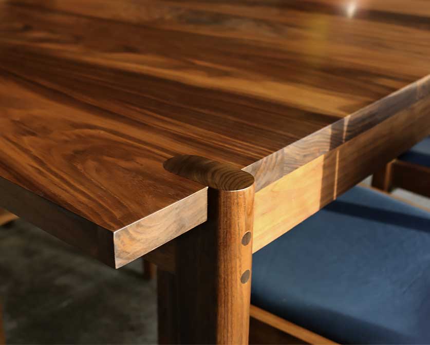 Sebastian Dining Table leg detail in Eastern Walnut