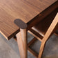 Wooden table and chairs on a gray floor