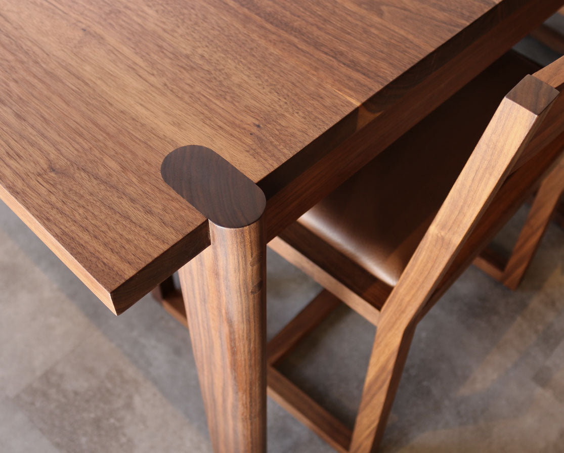 Wooden table and chairs on a gray floor