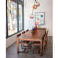 Dining area with wooden table and chairs near a large window.