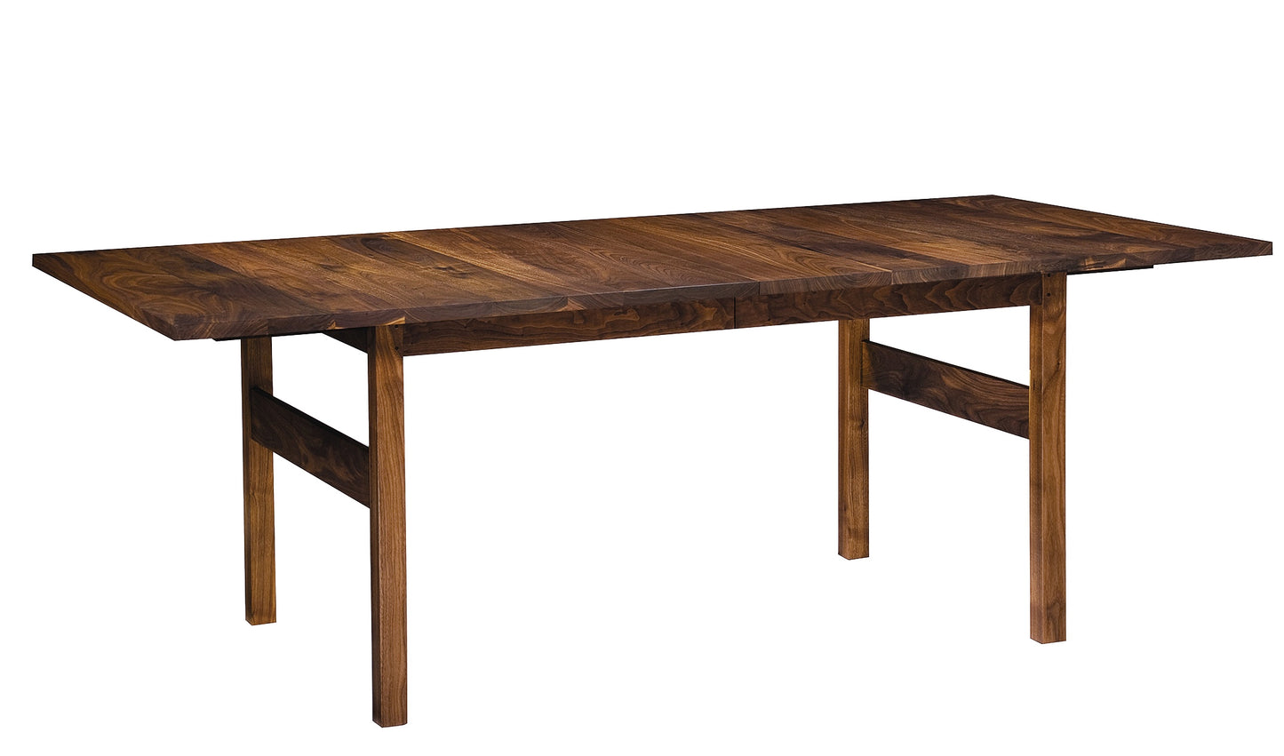 A dark brown wooden dining table with a rectangular top, visible wood grain, and four legs with stretcher supports, shown on a plain white background.