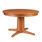 A round wooden pedestal dining table with a warm medium-brown finish, featuring a four-star base and a smooth oval tabletop, shown against a plain white background.