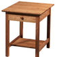 A warm Cherry wooden end table with a single drawer, round wooden knob, and an open lower shelf, shown on a plain white background.