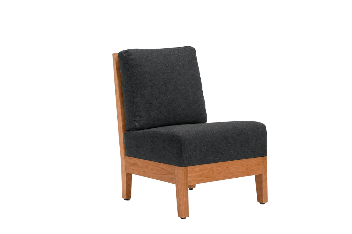 A modern accent chair with a dark charcoal gray fabric cushioned seat and backrest, supported by a light brown wooden frame, shown against a plain white background.