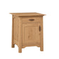 A small oak nightstand with a single drawer and one cabinet door, featuring dark wood handles and a natural wood grain finish, shown on a plain white background.