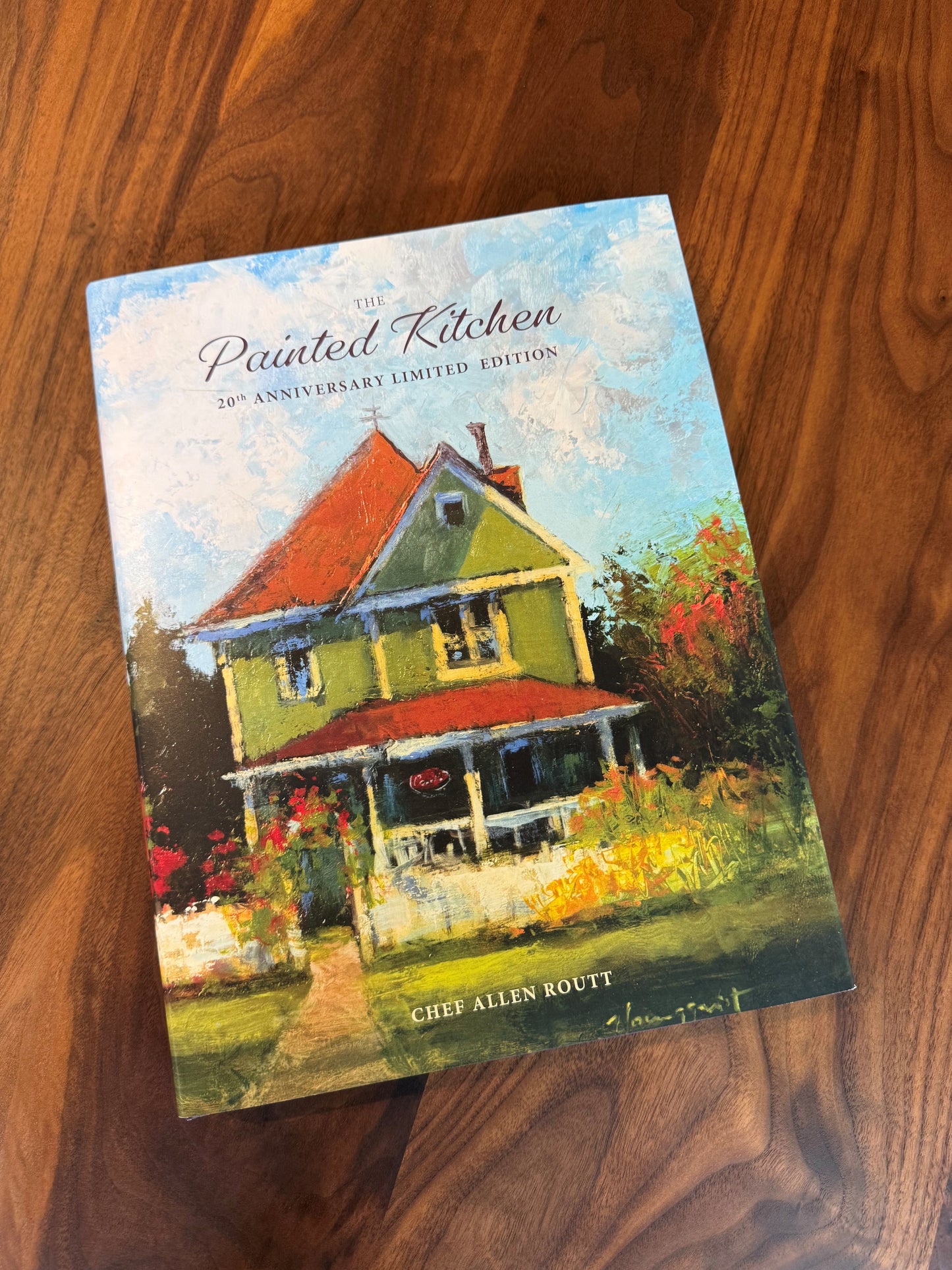 Book titled 'The Painted Kitchen' on a wooden surface