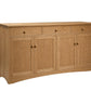 A light oak wood sideboard cabinet with three drawers on top, two double doors below, and small round brass knobs, shown on a plain white background.
