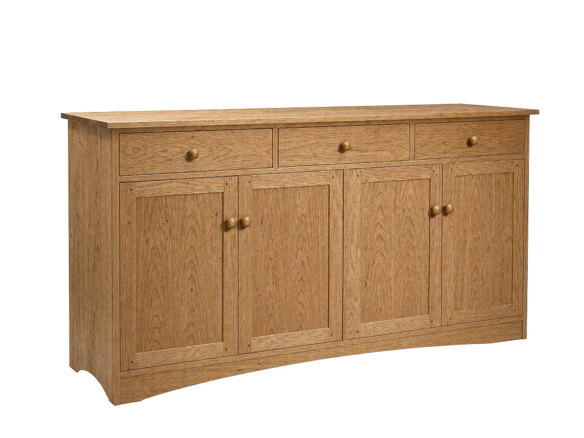 A light oak wood sideboard cabinet with three drawers on top, two double doors below, and small round brass knobs, shown on a plain white background.