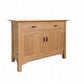 A light oak wood sideboard cabinet with two drawers on top and two paneled doors below, featuring dark wood handles, shown on a plain white background.