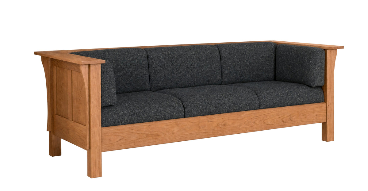 A three-seater wooden sofa with dark charcoal gray textured cushions, shown from a three-quarter angle on a solid white background.