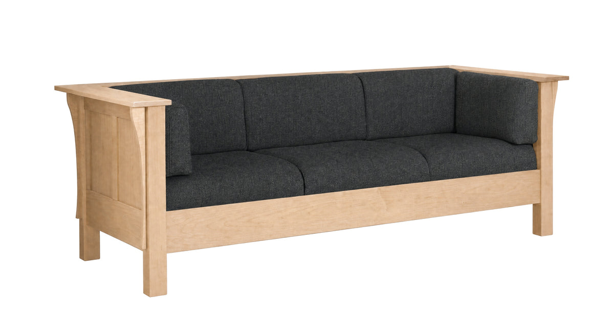 A three-seat wooden sofa with a light natural oak frame and dark charcoal gray fabric cushions, shown from a three-quarter angle on a white background.
