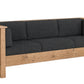 A rustic three-seater sofa with a natural oak wood frame and dark charcoal gray fabric cushions, shown from a three-quarter angle on a white background.
