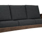 A three-seat wooden sofa with dark charcoal gray textured cushions, featuring a rustic brown wood frame and armrests, shown against a plain white background.