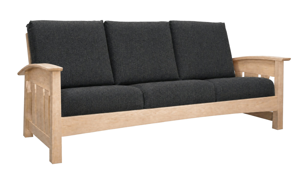 A wooden three-seat sofa with dark charcoal gray fabric cushions, shown from a three-quarter angle on a solid white background.