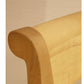 Wooden headboard against a beige wall