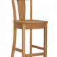A wooden barstool with a natural oak finish, featuring a curved backrest, square seat, and front support brace, shown against a plain white background.