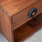 Wooden drawer with a blue handle on a light gray background
